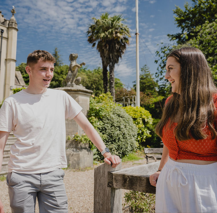 Two students outside the Abbey on Singleton Campus