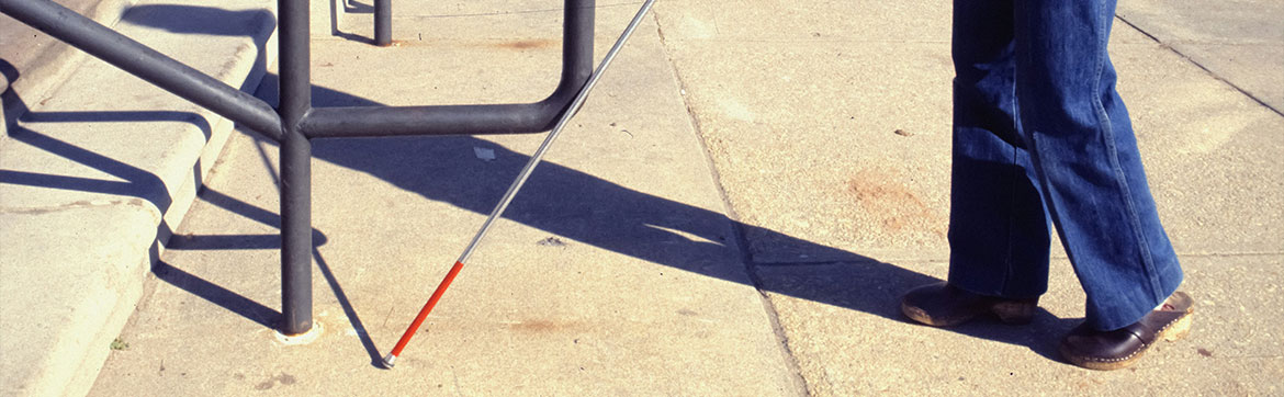 A blind person walking on the street