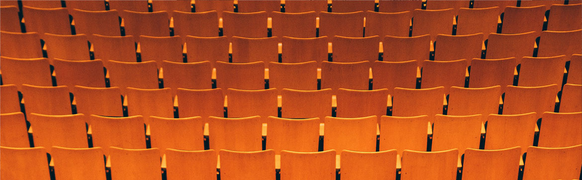 Chairs repeated across a theatre