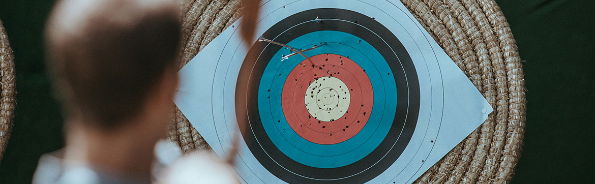 A person aiming at an archery target