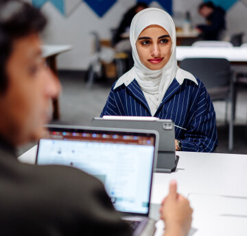 Students looking at a laptop 