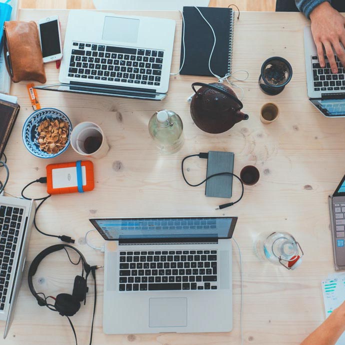 Image of laptops and headphones on a desk