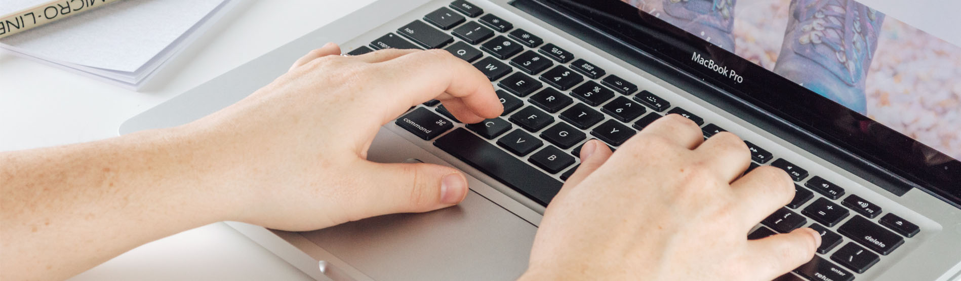 An image of a student working at a laptop