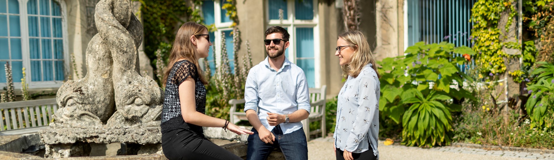 three people sitting outside