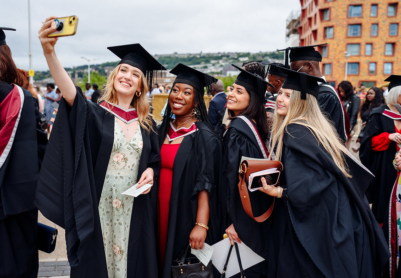 a group of graduates taking a selfie