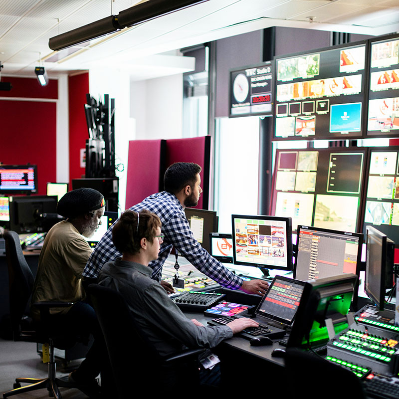 Three people working in a TV studio