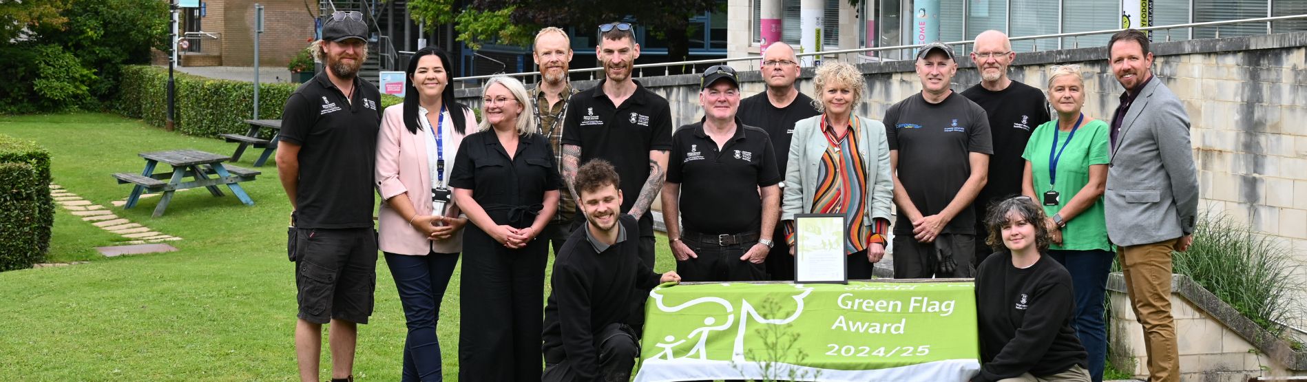 Grounds team poses for a photo with Niamh Lamond as they celebrate winning the green flag award