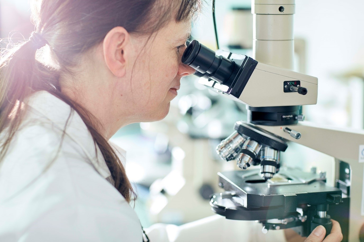 student with microscope