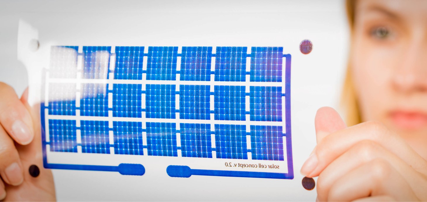 Woman holds a solar cell on a flexible film.