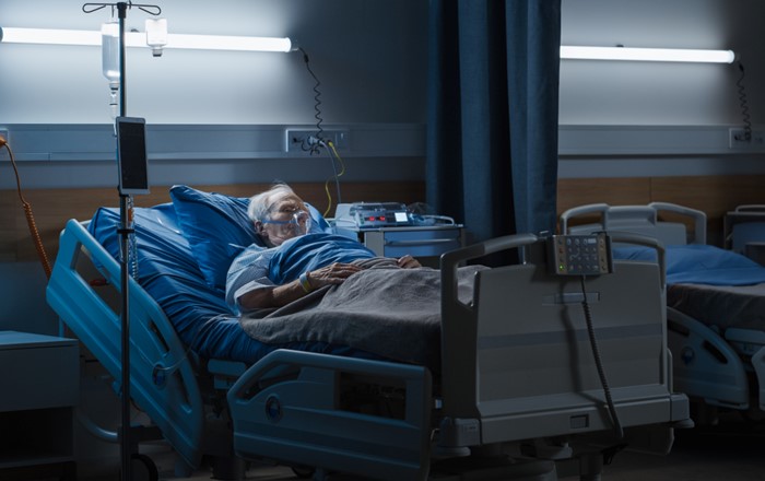 Elderly male patient lying in a hospital bed