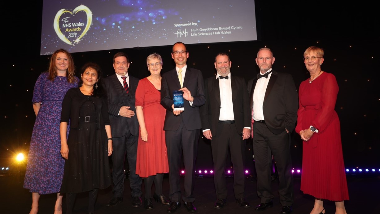 A group photo of the PROSTAD team on stage as they accept the award for NHS Wales Efficient Care.