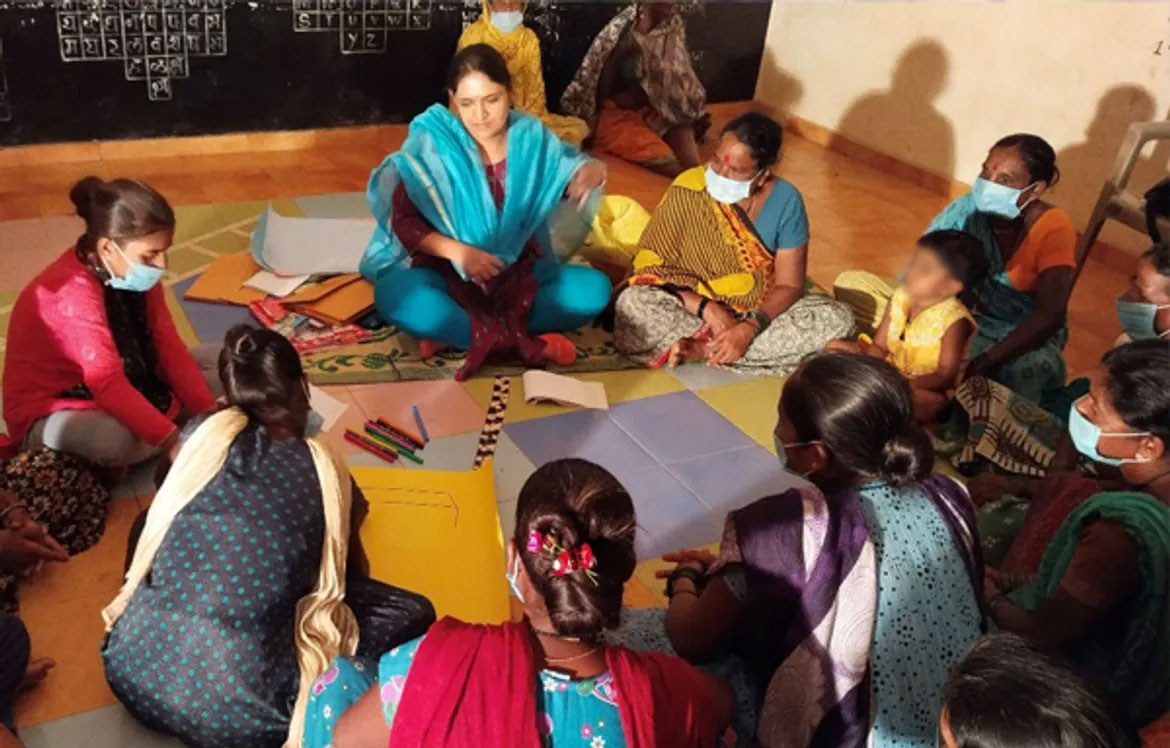 Woman in India sitting in a circle on the floor