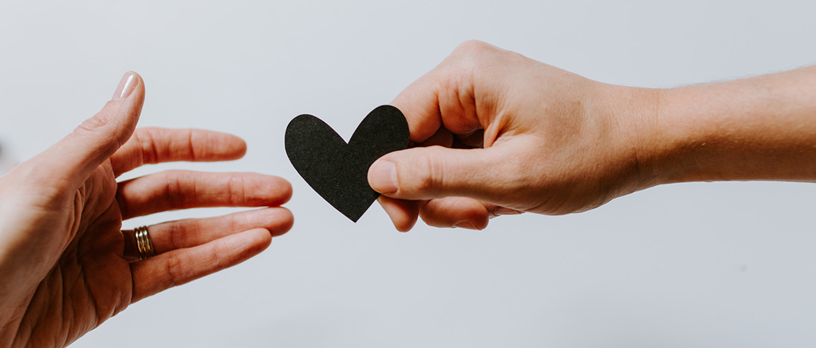 Photo of hands reaching out with a heart