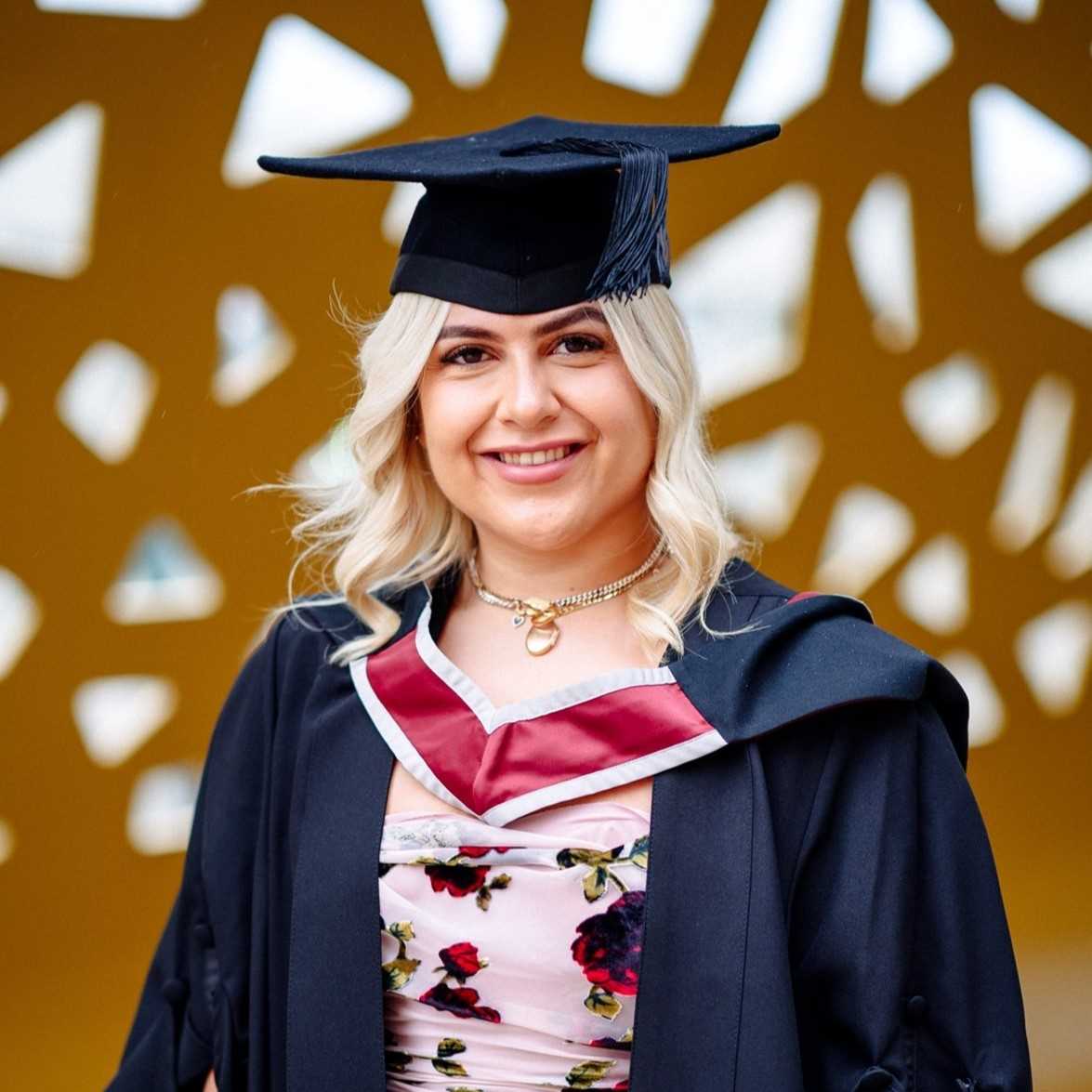 headshot of Carys at graduation