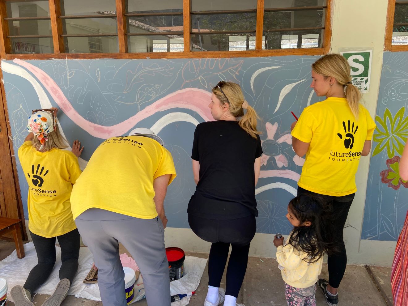 Students painting a wall