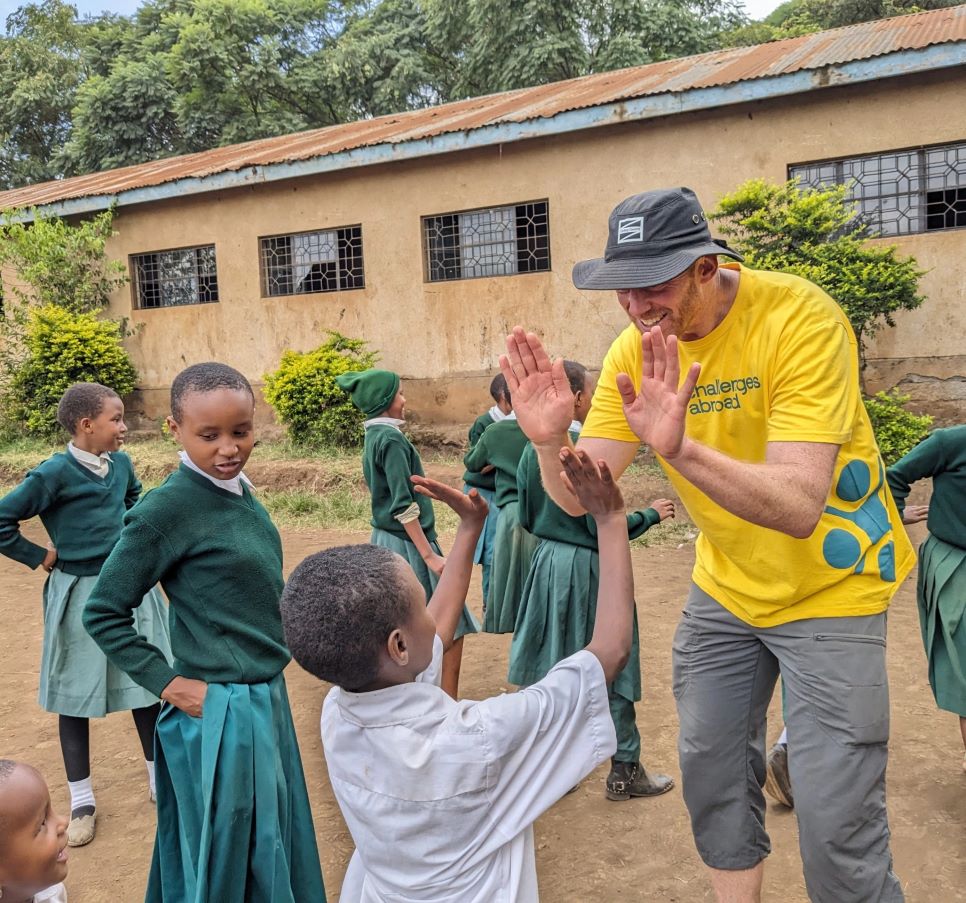 Volunteer high-fiving children