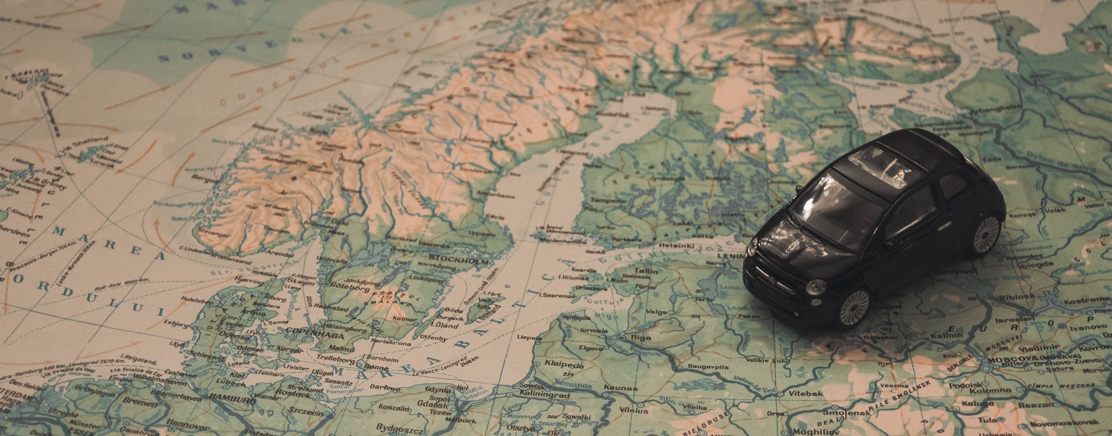 Toy car placed on a map of Northern Europe.