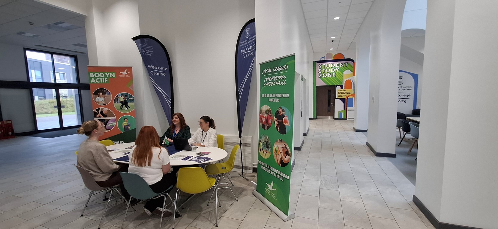 Students talking to staff at The College's Help Desk