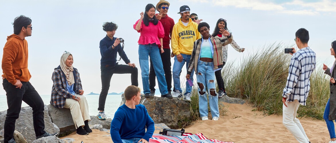 group of students at bay campus beach