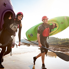 Students on the beach with canoes